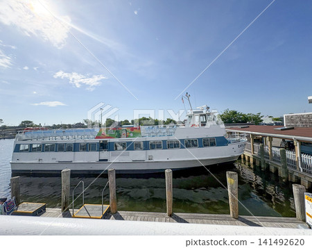 Fire Island Ferry Boat Docks at Harbor Ready for Passengers in Sunny Weather Fire Island Ferry Boat Docks at Harbor Ready for Passengers in Sunny Weather 141492620