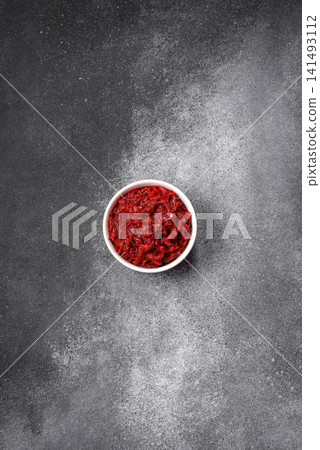 Grated beetroot with salt and spices as an ingredient for borscht or a vegan salad. Grated beetroot 141493112