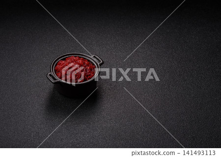 Grated beetroot with salt and spices as an ingredient for borscht or a vegan salad. Grated beetroot Grated beetroot with salt and spices as an ingredient for borscht or a vegan salad. Grated beetroot 141493113
