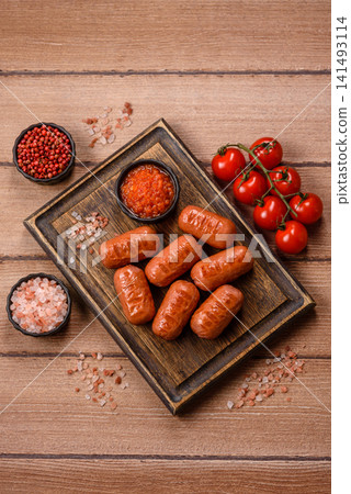 Chicken or pork grilling sausages with garlic, salt, and spices. Grilling sausages Chicken or pork grilling sausages with garlic, salt, and spices. Grilling sausages 141493114