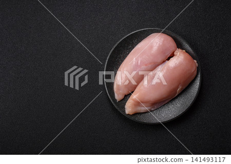 Fresh raw chicken fillet with salt and spices for home cooking. Raw chicken fillet Fresh raw chicken fillet with salt and spices for home cooking. Raw chicken fillet 141493117