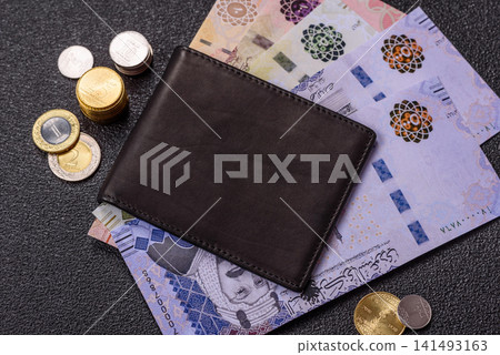 Saudi Arabia paper money, riyal banknotes and coins as currency for exchange. Saudi Arabia money Saudi Arabia paper money, riyal banknotes and coins as currency for exchange. Saudi Arabia money 141493163