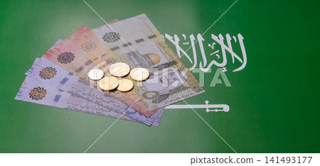 Saudi Arabia paper money, riyal banknotes and coins as currency for exchange. Saudi Arabia money Saudi Arabia paper money, riyal banknotes and coins as currency for exchange. Saudi Arabia money 141493177