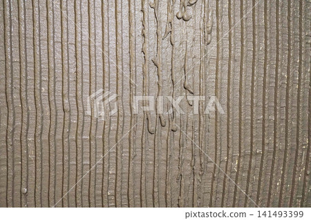 Textured Surface with Vertical Stripes of Wet Cement or Mortar Depicting an Artistic Design Textured Surface with Vertical Stripes of Wet Cement or Mortar Depicting an Artistic Design 141493399