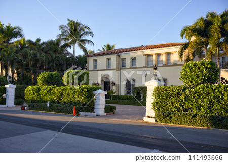 Mediterranean Style Mansion Behind Manicured Hedges At Sunset Mediterranean Style Mansion Behind Manicured Hedges At Sunset 141493666