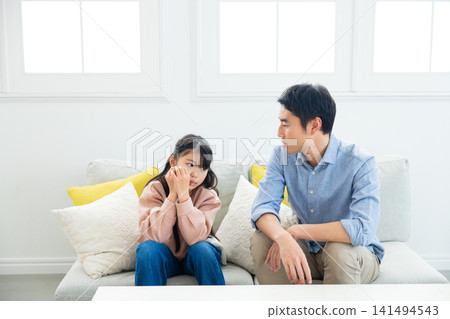 A father and his elementary school-aged daughter having a conversation. A father and his elementary school-aged daughter having a conversation. 141494543