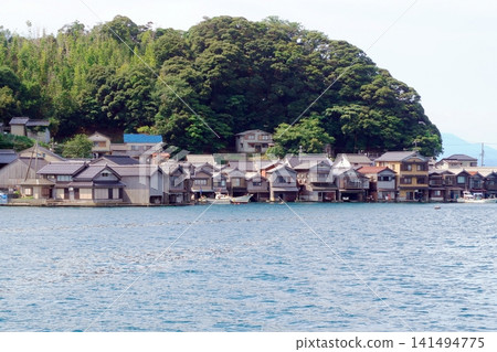 A landscape lined with boathouses A landscape lined with boathouses 141494775