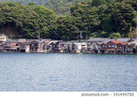 A landscape lined with boathouses A landscape lined with boathouses 141494780