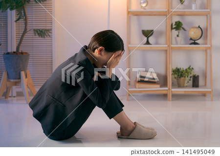 Woman in suit depressed Woman in suit depressed 141495049
