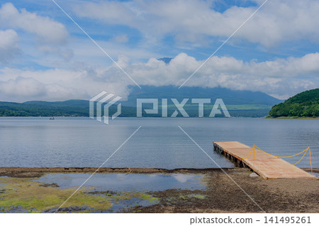 Mount Fuji shrouded in clouds, as seen from Lake Yamanaka Mount Fuji shrouded in clouds, as seen from Lake Yamanaka 141495261