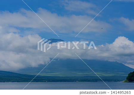 Mount Fuji shrouded in clouds, as seen from Lake Yamanaka Mount Fuji shrouded in clouds, as seen from Lake Yamanaka 141495263