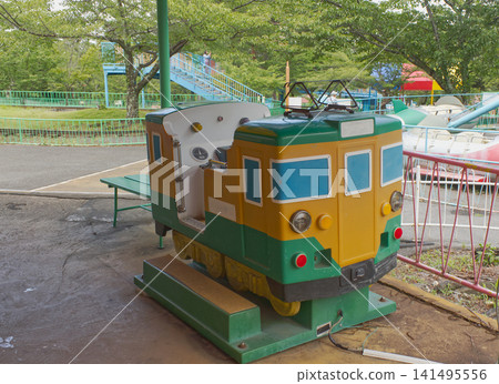 A nostalgic coin-operated train ride in a retro park, a scene reminiscent of the Showa era. 141495556