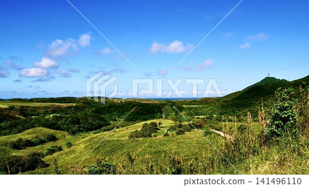 The magnificent pastures of Yonaguni Island spread out under the blue sky. The magnificent pastures of Yonaguni Island spread out under the blue sky. 141496110
