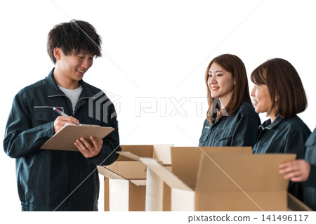 A worker of a transportation, logistics, courier, distribution, delivery, or delivery company packing packages into cardboard boxes A worker of a transportation, logistics, courier, distribution, delivery, or delivery company packing packages into cardboard boxes 141496117