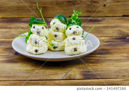 Christmas salad in the shape of snowmen and Christmas tree on a plate on wooden table Christmas salad in the shape of snowmen and Christmas tree on a plate on wooden table 141497260