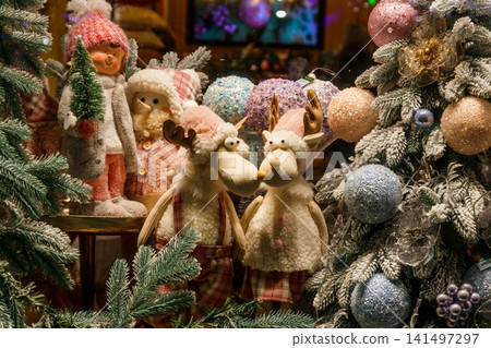 Christmas and New Year's toys in a store. Festive winter Christmas trade Christmas and New Year's toys in a store. Festive winter Christmas trade 141497297