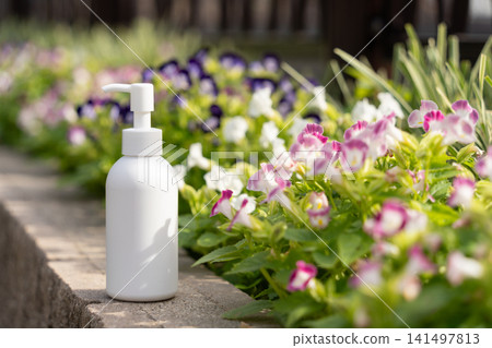 Flowers in the flowerbed and beauty bottles 141497813