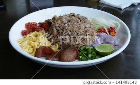 Brown rice plate egg sausage chili lime vegetable side on white bowl Brown rice plate egg sausage chili lime vegetable side on white bowl 141498148