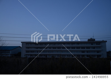 The disused former Namie High School building in Namie Town, Fukushima Prefecture, stands against the blue twilight sky. The disused former Namie High School building in Namie Town, Fukushima Prefecture, stands against the blue twilight sky. 141498955