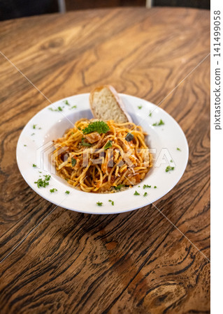 Fresh Spaghetti Marinara with Parmesan Cheese and Artisan Bread on Rustic Wooden Restaurant Table Fresh Spaghetti Marinara with Parmesan Cheese and Artisan Bread on Rustic Wooden Restaurant Table 141499058