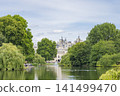 London's St. James's Park and its fountain, surrounded by blue skies and lush greenery. 141499470