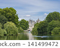 London's St. James's Park and its fountain, surrounded by blue skies and lush greenery. 141499472