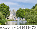 London's St. James's Park and its fountain, surrounded by blue skies and lush greenery. 141499473