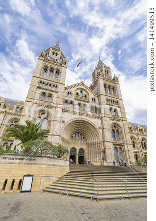 The historic facade of the Natural History Museum in London against a blue sky. London, England. The historic facade of the Natural History Museum in London against a blue sky. London, England. 141499513