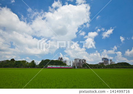 A train running through rural and industrial areas. A train running through rural and industrial areas. 141499716