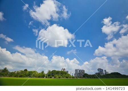 A train running through rural and industrial areas. A train running through rural and industrial areas. 141499723