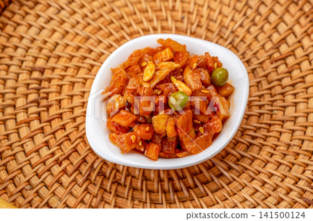 spicy pickled radish cubes seasoned with chili sauce and peas 141500124