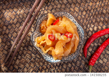 traditional pickled radish strips seasoned with spicy chili slices traditional pickled radish strips seasoned with spicy chili slices 141500235