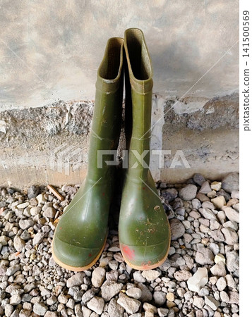 a pair of boots next to the wall 141500569