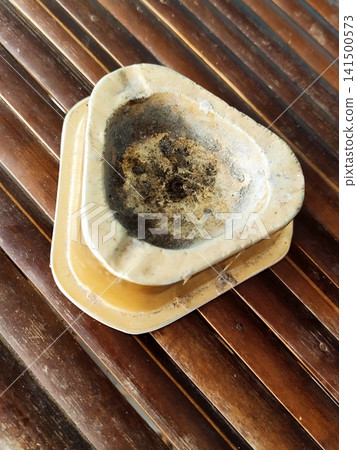 cigarette butt ashtray on bamboo table 141500573