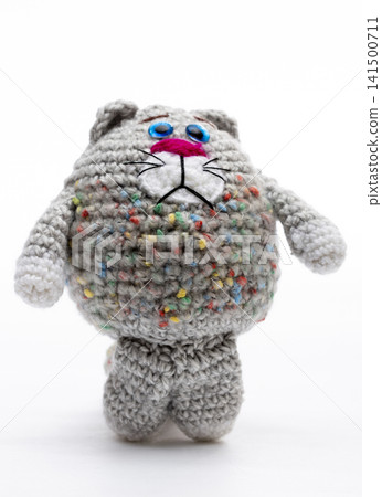 Knitted cat on a white background Knitted cat on a white background 141500711