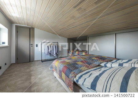 Bedroom Interior with Beds, Wardrobe, and Clothing Rack Bedroom Interior with Beds, Wardrobe, and Clothing Rack 141500722