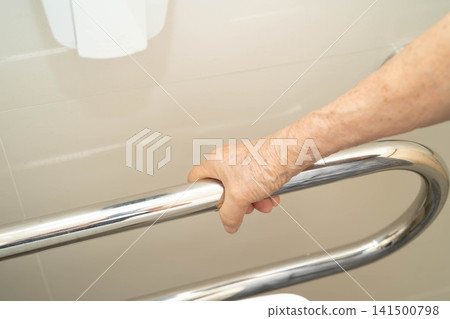 Asian elderly woman use safety handrail in bathroom. Asian elderly woman use safety handrail in bathroom. 141500798