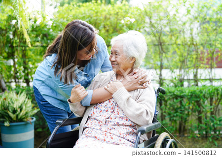 Caregiver help Asian elderly woman disability patient sitting on wheelchair in park, medical. Caregiver help Asian elderly woman disability patient sitting on wheelchair in park, medical. 141500812