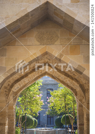 Vertical stone arch in old Baku with carved medallion and copy space 141500824