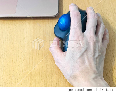 Hands operating the trackball Hands operating the trackball 141501224