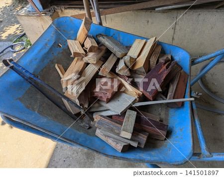 A wheelbarrow loaded with scraps of wood for DIY projects. A wheelbarrow loaded with scraps of wood for DIY projects. 141501897