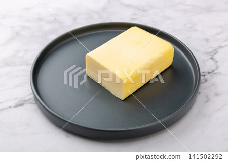 solid block of premium cultured butter, rich fermented dairy cream for gourmet baking and culinary cooking. solid block of premium cultured butter, rich fermented dairy cream for gourmet baking and culinary cooking. 141502292
