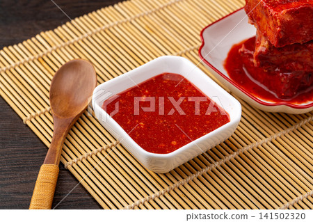 traditional Tianjin style fermented bean curd cubes coated in rich spicy red chili oil, savory preserved sufu delicacy. traditional Tianjin style fermented bean curd cubes coated in rich spicy red chili oil, savory preserved sufu delicacy. 141502320