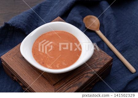 creamy fermented bean curd dipping sauce, smooth savory pink sufu paste for traditional hot pot and marinating. creamy fermented bean curd dipping sauce, smooth savory pink sufu paste for traditional hot pot and marinating. 141502329