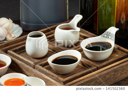 assorted traditional Asian cooking condiments and liquid seasonings, essential savory sauces for culinary flavor. assorted traditional Asian cooking condiments and liquid seasonings, essential savory sauces for culinary flavor. 141502360