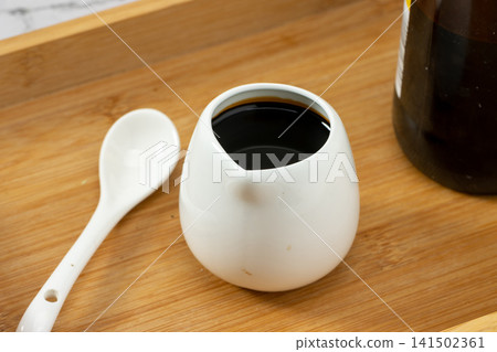 traditional dark soy sauce, fermented umami liquid condiment for authentic Asian cooking and dipping. traditional dark soy sauce, fermented umami liquid condiment for authentic Asian cooking and dipping. 141502361