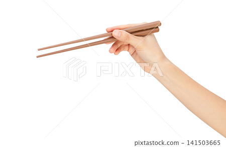 Clipping path, hand holding wooden chopsticks isolated on white background. 141503665
