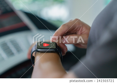 Hand of woman using smartwatch to monitor heart rate and health data Hand of woman using smartwatch to monitor heart rate and health data 141503721