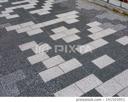 Monochromatic interlocking paving; geometric patterns spread across the sidewalk. Monochromatic interlocking paving; geometric patterns spread across the sidewalk. 141503951