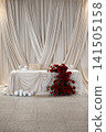 Elegant wedding reception table decorated with red roses and candles 141505158